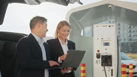 Two focused multiracial business partners in formal attire working on wireless Stock Footage 245270911