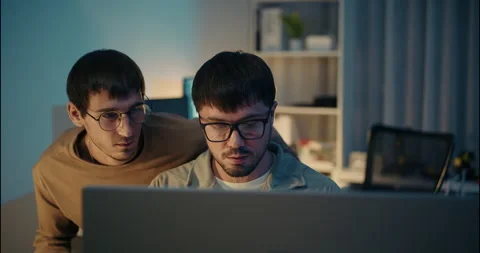 Two Focused Programmers Analyzing Code on Screen at Night. Video stock 306739093