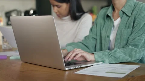 Two focused women working on computer at home 库存影片 231758032