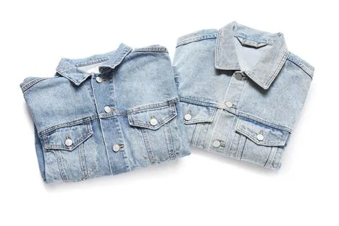 Two folded light blue denim jackets with metal buttons and chest pockets, cas Foto stock