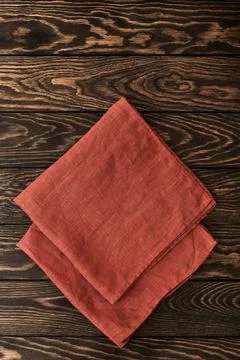Two folded linen napkins on a wooden table with copy space, top view Stock Photos
