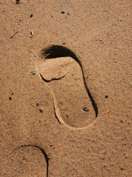 Two footprints in light brown sand Stock-Fotos
