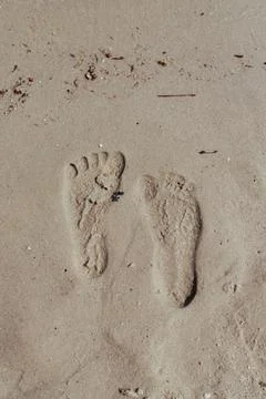 Two Footprints in sand at the Beach Stock Photos