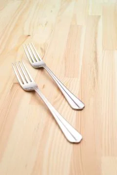 Two fork on a pinewood table Stock Photos