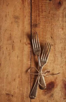 Two fork tied by string on old wood, background Stock Photos