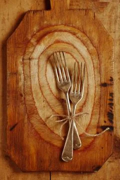 Two fork tied by string on old wood, background Stock Photos