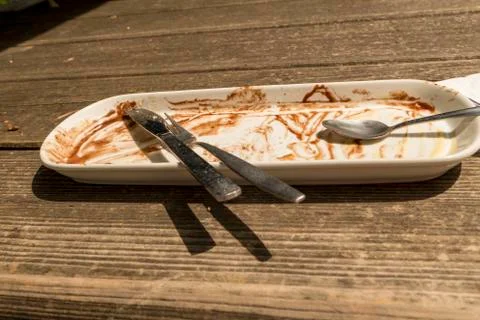 Two forks with napkin on the empty table Stock Photos