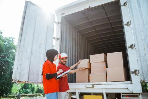 Two forwarders checking boxes of delivery packages in a cargo Stock Photos