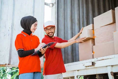 Two forwarders checking boxes of shipping packages in a cargo Stock Photos