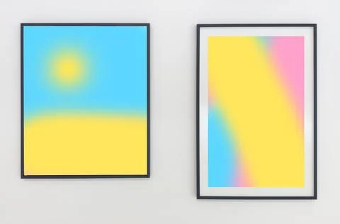 Two framed abstract gradient prints hanging on a gray wall. Left frame shows  Stockfoto's