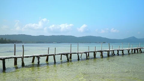 Two frames in video. Beautiful woman walking down pier in long red dress. Phu Stock Footage 87525218