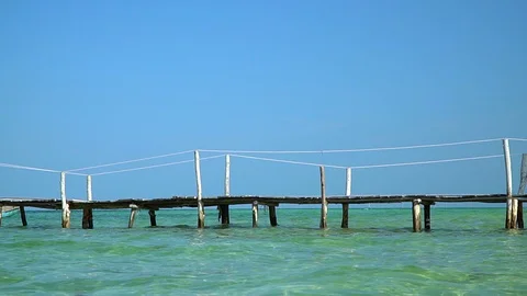 Two frames in video. Beautiful woman walking down pier in long red dress. Phu Stock Footage 87527336