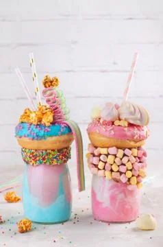 Two freak shake topping with donut and marmalade over grey background Stock Photos