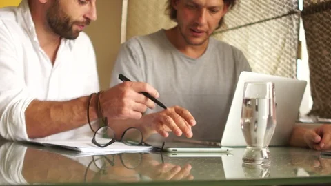 Two freelancers are working on a project in a rented office. Supervisor and Stock Footage 97494618