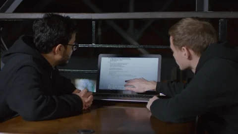 Two Freelancers Discussing Program Code Together Stock Footage 105291399