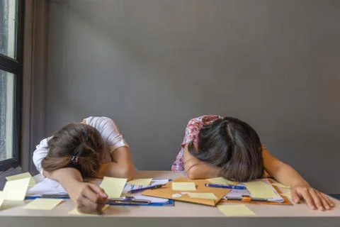 Two freelancers lay down on table full of financial report Stock Photos