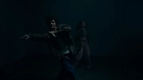 Two Freestyle Dancers with Flashing Lights illuminating Scene Stock Footage 335686589