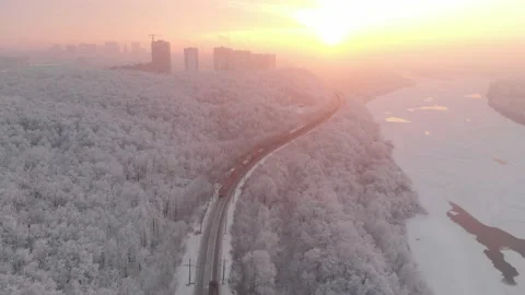Two freight trains go towards through winter forest. Aerial fliyng 動画素材 146320649
