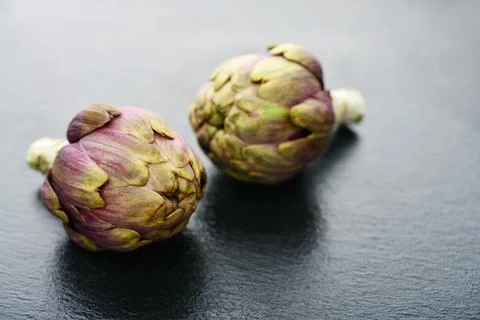 Two fresh artichokes Stock Photos