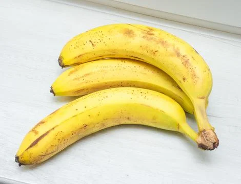 Two fresh bananas on the kitchen table, ripe bananas Stock Photos