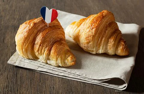 Two fresh croissants on a table Stock Photos