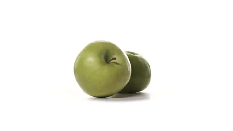 Two fresh green apples are spinning on white background. Freshly picked sour or Stock Footage 148507720