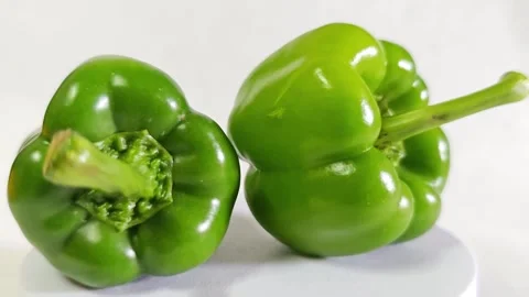 Two fresh green bell peppers close up on white background. Stock Footage 340938175