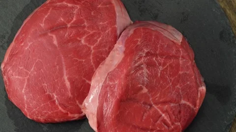 Two fresh juicy raw beef steaks. Close-up studio shooting Video stock 159062868