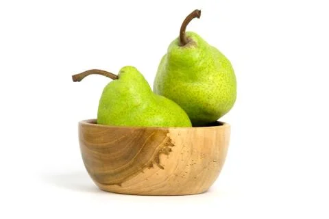 Two fresh Packham pears fruit above wooden bowl isolated on white background Stock Photos