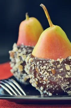 Two fresh pear with chocolate icing Stock Photos