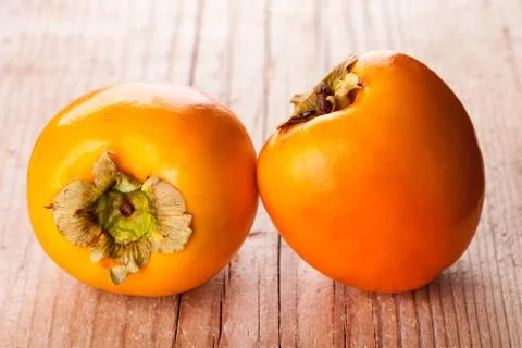 Two fresh persimmons Stock Photos