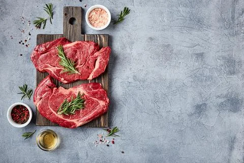 Two Fresh Raw meat Prime Black Angus Beef Steaks, Rib Eye, Denver, on wooden Stock Photos