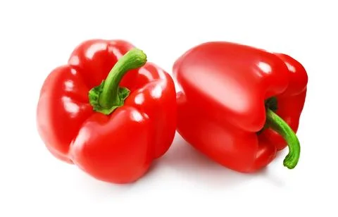 Two fresh red bell pepper vegetables are isolated on a white background. Th.. Stock Photos