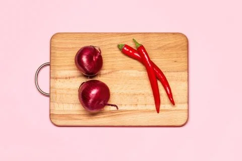 Two Fresh Red Chilli Pepper Near Two Violet Bows Stock Photos