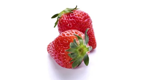 Two fresh strawberries rotating on a white background Stock Footage 332911356