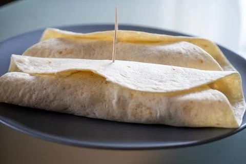 Two fresh tortilla wraps placed on a gray plate Foto stock