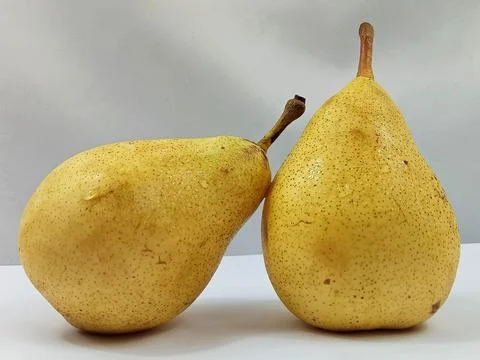 Two Fresh Yellow Pears on Neutral Background Stock Photos