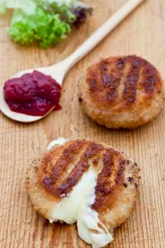 Two fried camembert cheeses in bread crumbs Stock Photos