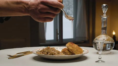 Two fried cutlets and bulgur on a plate Stock Footage 147546555