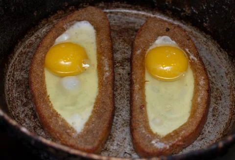 Two fried eggs in bread crust Stock Photos