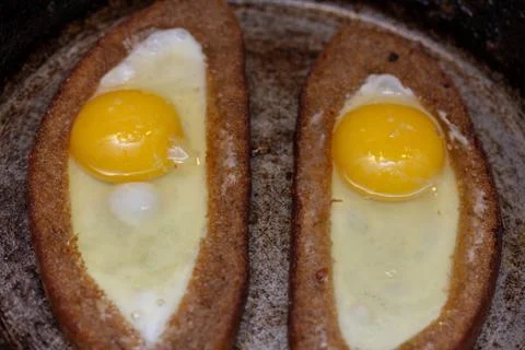 Two fried eggs in bread crust Stock Photos