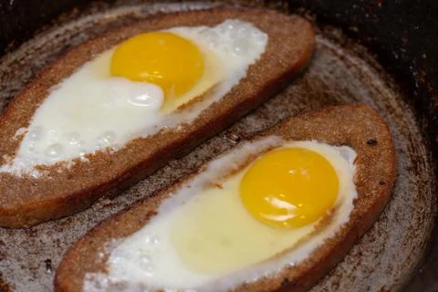 Two fried eggs in bread crust Stock Photos