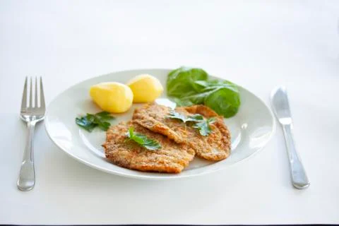 Two fried fish fillet from the flatfish flounder with potatoes, spinach Foto stock