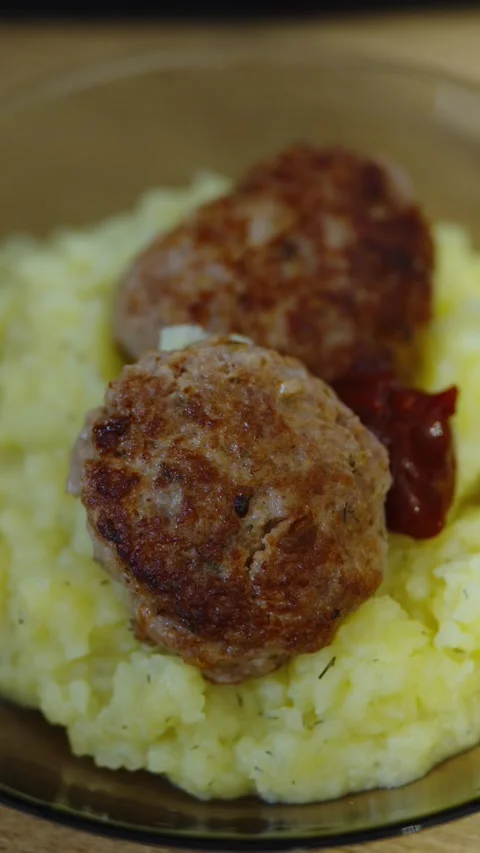 Two fried meat cutlets are served on mashed potatoes. Stock Footage 339210578
