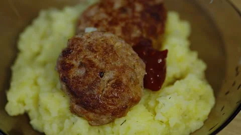 Two fried meat cutlets are served on mashed potatoes. Stock Footage 339210623
