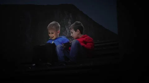 Two friendly classmates spend time together use a smartphone. Stock Footage 167381157