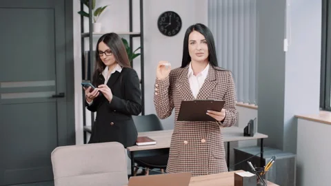 Two friendly young diverse business women standing in office Video stock 246805830
