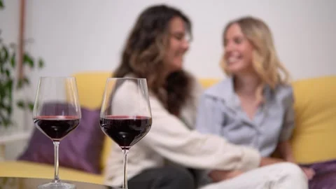 Two friends are catching up while having red wine in the intimacy Stock Footage 278488409