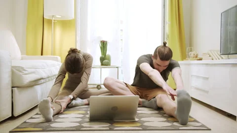 Two friends are doing stretch exercises Stock Footage 156480612