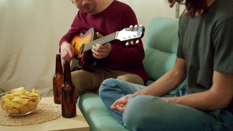 Two friends are playing guitar and singing songs Stock Footage 160628034